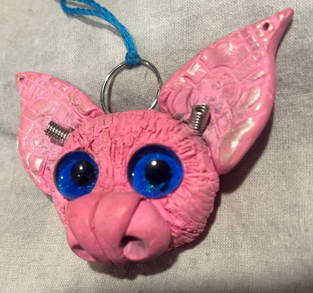 Batticus sculpted bat pendant, angled view showing blue glass eyes and patterned ears
