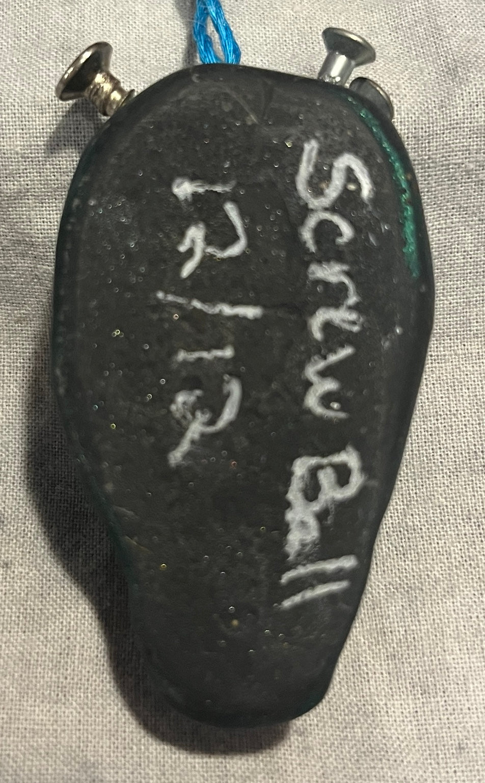 Back of Screwball handmade sculpted pendant with artist signature