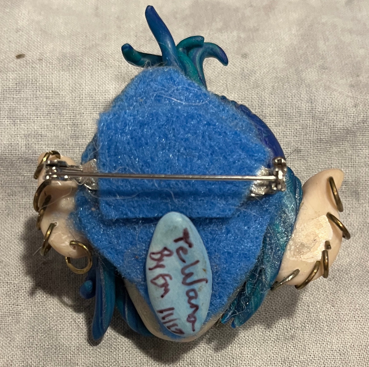 Back of TeWana Asteria handmade brooch showing felt backing and pin